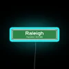 Neon sign displaying Raleigh, North Carolina in vibrant blue.