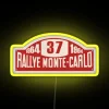 alt text: neon sign from monte carlo rally 1964 with vibrant yellow and rgb lighting
