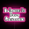 Rather be doing gymnastics neon RGB sign with pink glow.
