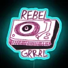 A rebel grrrl with a record player under an RGB neon sign in blue.