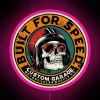 A retro motorcycle built for speed, featuring an RGB neon pink sign.