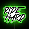 neon sign saying ride hard - green
