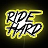 ride hard neon sign with vibrant rgb lighting, yellow neon glow.