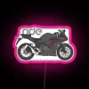 Honda CBR500R motorcycle featuring a black base with RGB neon sign and pink accents.