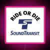 rgb neon sign displaying ride or die sound transit in vibrant pink.