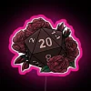 A vibrant RGB neon pink and red D20 die, perfect for tabletop gaming sessions.