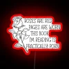neon sign displaying roses are red pages are worn book reading themed design with vibrant rgb and red tones