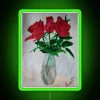 RGB neon sign displaying roses in vibrant green tones.