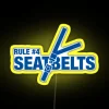 Neon sign displaying Rule 4 seat belt regulation in yellow.