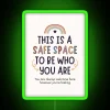 Neon sign displaying 'Safe Space to Be Who You Are' with vibrant RGB lighting effects and a green glow.