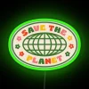 RGB neon sign displaying 'Save The Planet' in green.