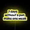 Neon sign displaying 'Seven days without a pun makes one weak' - humorous and clever phrase.