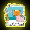 Neon sign displaying a yellow cat with sew.