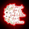 neon sign displaying she is fierce in bold rgb colors with vibrant red glow.