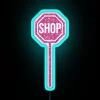 A vibrant shop sign featuring pink glitter and RGB neon lighting effects.