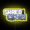 rgb neon sign displaying 'shred the gnar' in vibrant yellow