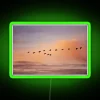 Green glowing neon sign reading 'Skein of Guess in Flight' in bold, cursive font.