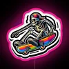 Colorful skeleton on a skateboard, depicted in vibrant pink and blue neon lights against a dark background.