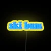 Vibrant yellow LED neon sign featuring a ski bum logo in bold, bright colors
