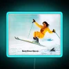Colorful neon ski girl silhouette against a blue background.
