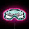 Ski goggles with neon RGB details against a pink background
