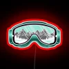 Close-up of neon-colored ski goggles on a dark background, with colorful accents and reflections.