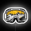 Neon-colored ski goggles and snowboard accessories on a white background, ideal gifts for thrill-seekers.