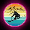 A vintage skier at a winter sports resort, illuminated by a neon sign in pink hues.