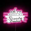 Neon pink skincare routine on a colorful digital sign.
