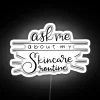 A vibrant neon-lit skincare routine sign on a colorful background.