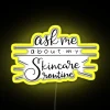 Neon skincare routine sign in yellow, displaying a vibrant list of beauty products.
