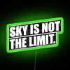 Neon RGB sign with inspirational phrase against a dark blue sky.