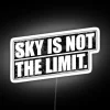Neon sign with colorful letters spelling out 'Sky is not the limit'