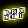 Neon sign with vibrant yellow colors against a dark blue sky.