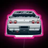 Nissan Skyline GT-R R32 with pink neon sign at night