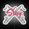 Neon sign featuring a bass clarinet with a futuristic, RGB-lit design in a white background.