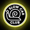 Neon-lit slow car club logo on a black background with yellow accents.
