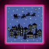 Cozy small town Christmas scene with neon sign on dusky blue evening backdrop.