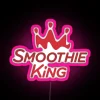 Neon Smoothie King cafe sign with pink glow.