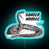 Neon sign featuring a snake in a noodle, symbolizing danger and fascination with reptiles.