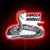 Colorful neon sign with a playful warning about loving snakes near noodles.