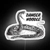 Neon sign reading 'Snake Lover Danger Noodle' in bold, colorful letters.