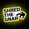 Neon snowboard sign with RGB colors and 'Shred the Gnar' design.