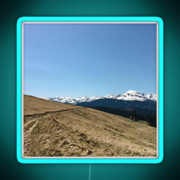Snowy Mountain Peaks And Forest Landscape On The RGB Neon Sign