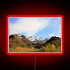 Mountainous landscape of Denali's snowy peaks with vibrant neon lights.