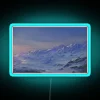 Neon sign with snow-capped mountains in RGB color scheme.