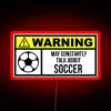 Neon soccer sign with red lights against a dark background