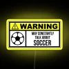 Soccer stadium lit up at night with neon signs