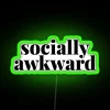 Neon sign with white letters displaying social awkwardness in green lighting.