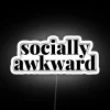 Neon sign with white letters reading 'Socially Awkward' in bold, RGB color.